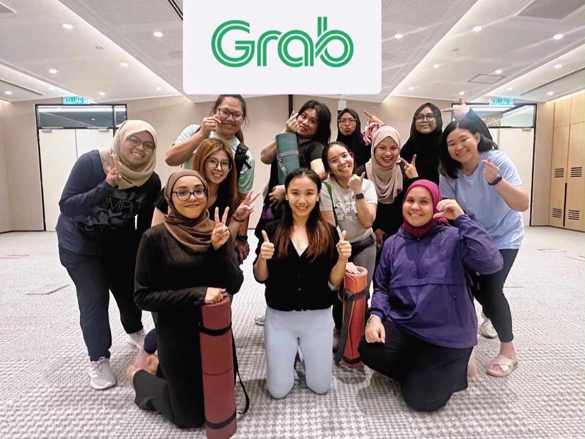 Cherrie with Grab Malaysia employees after a corporate Pilates group class