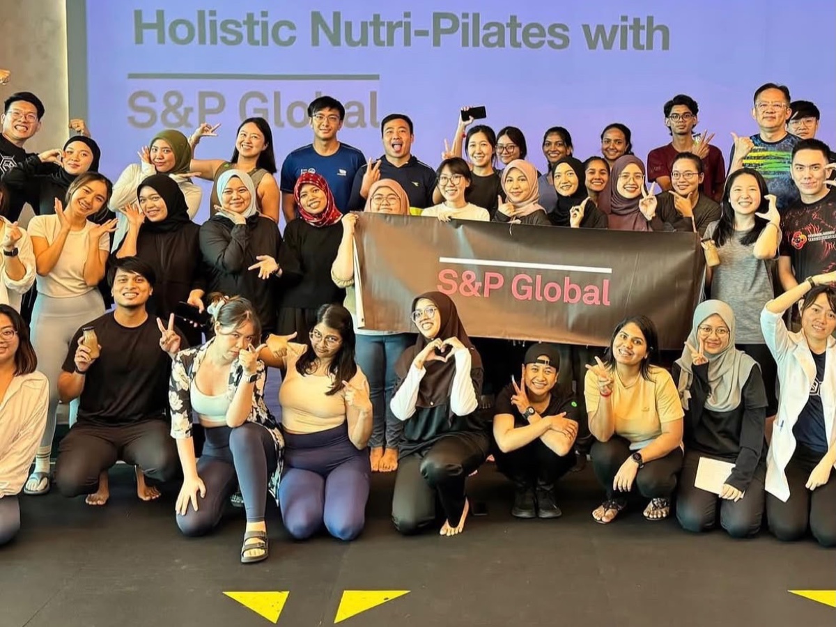 Cherrie with S&P Global Malaysia employees after the Holistic Nutri-Pilates workplace wellness session